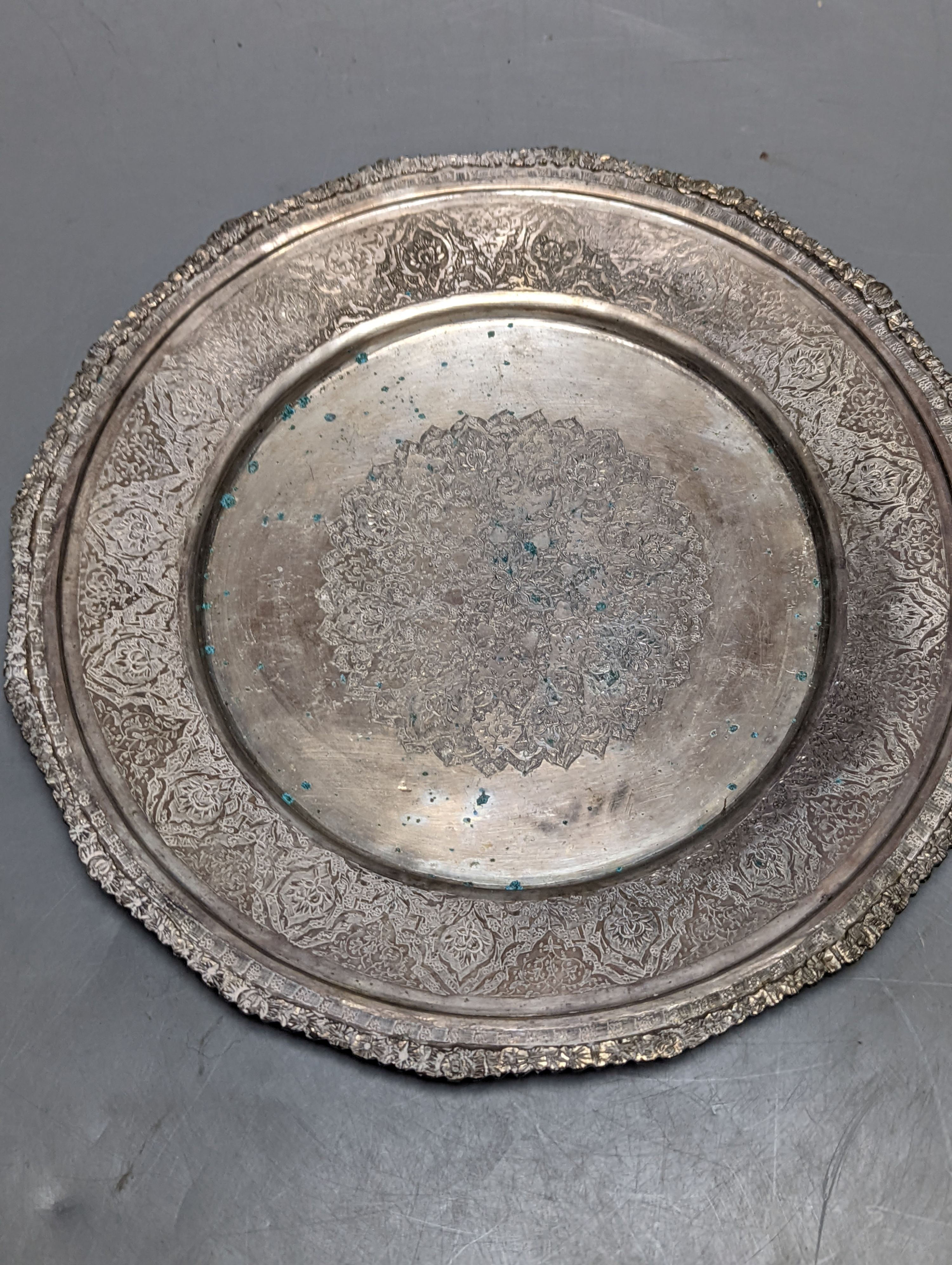 A Persian engraved white metal bowl, diameter 17.9cm and a similar stand or plate, 22cm, 20oz.